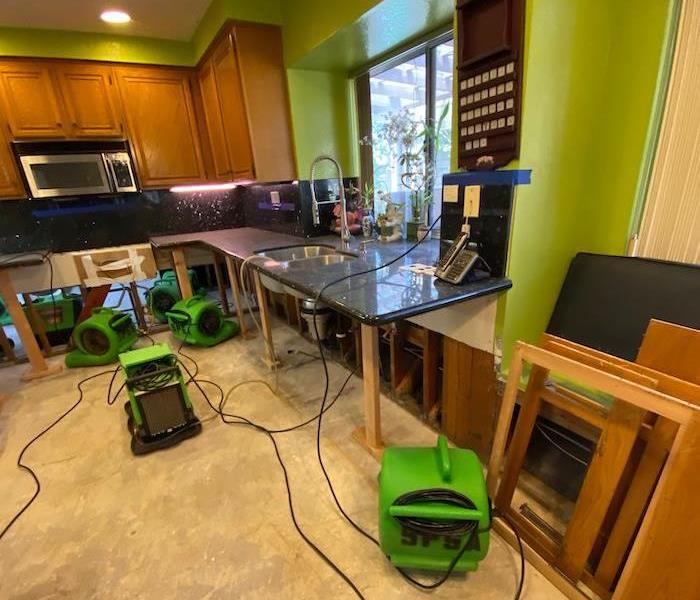 Kitchen with SERVPRO drying equipment on the floor 