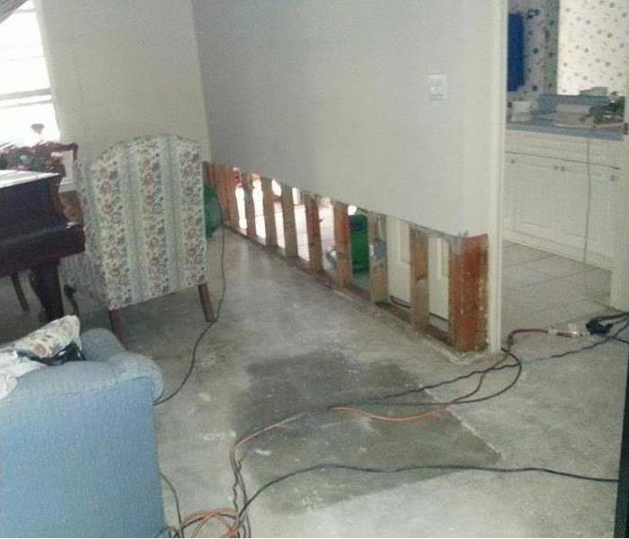 exposed studs, drywall removed, the equipment shown