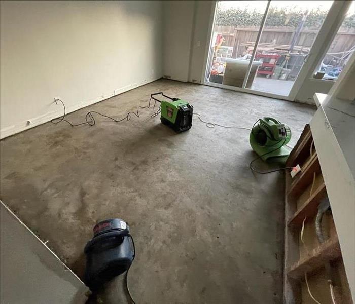 water damaged room; flooring removed; SERVPRO drying equipment being used to restore room