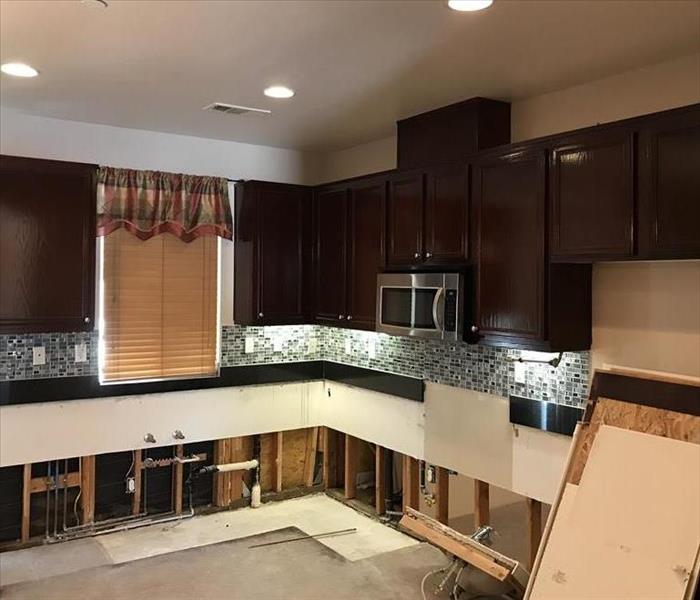 A kitchen with all of the cabinets and appliances removed. 