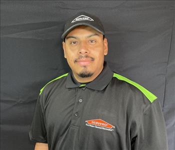 male posing, servpro black shirt, and background